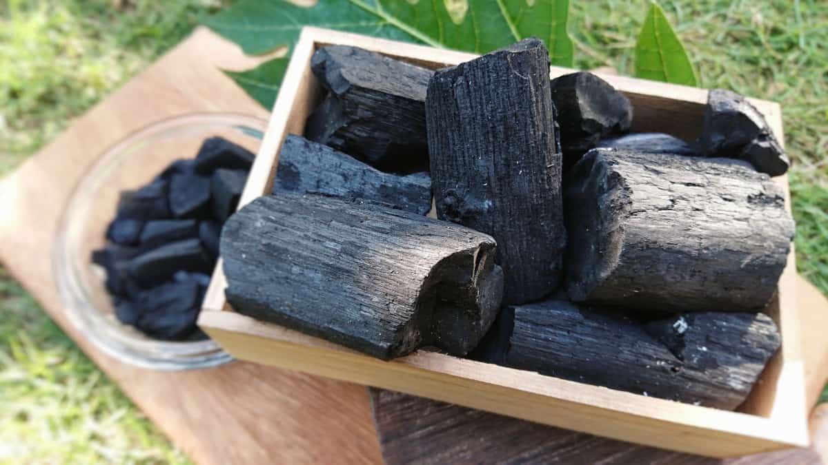 Fine looking natural hardwood charcoal in a wooden bas.