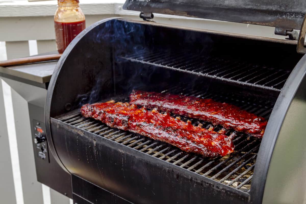 Two racks of pork ribs in a smo.