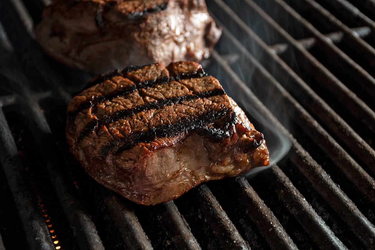 A seared filet mignon on an infrared gr.