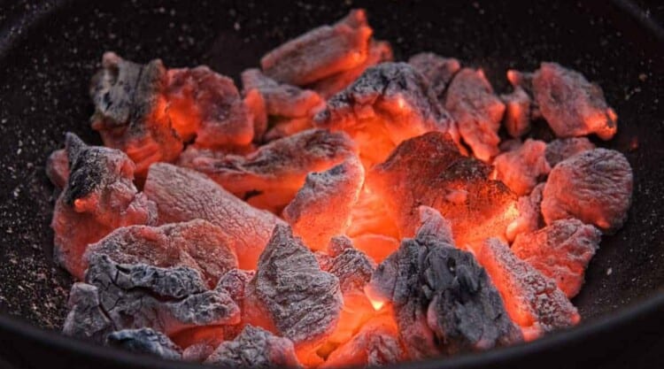 A charcoal grill full of hot, burning embers.