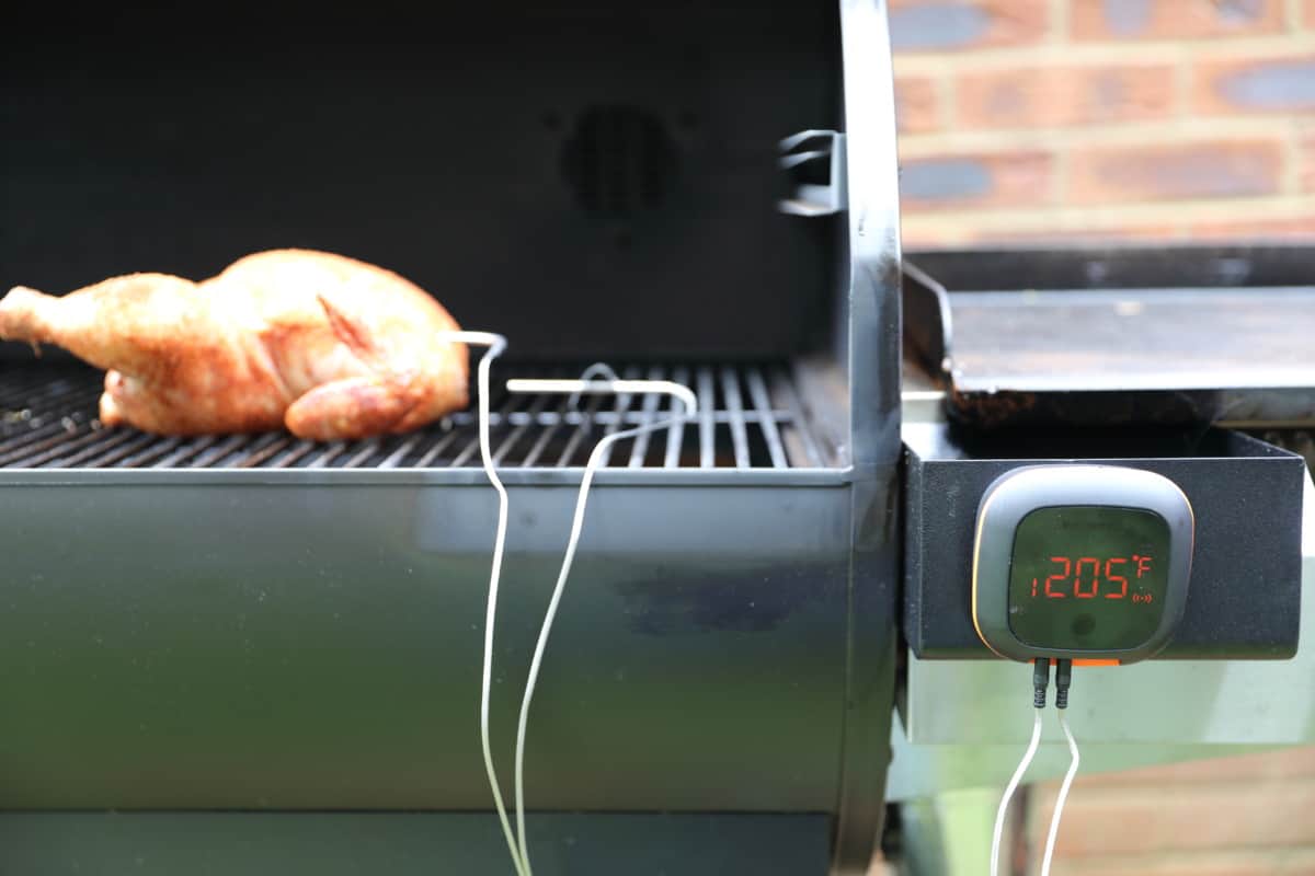 inkbird ibt-4xs on a pellet grill, being used to cook chic.