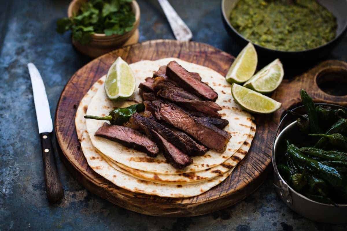 sliced skirt steak sitting on faji.