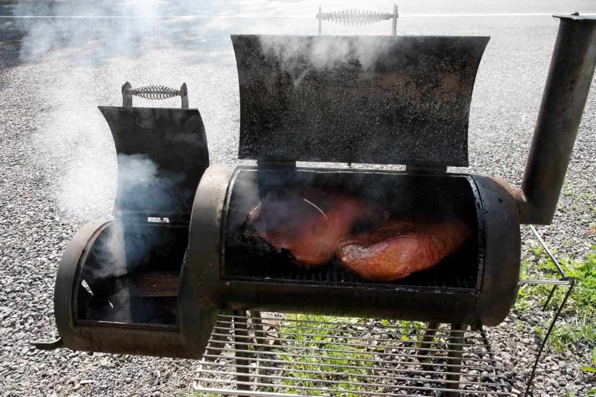 Smoker grill smoking ham and bris.