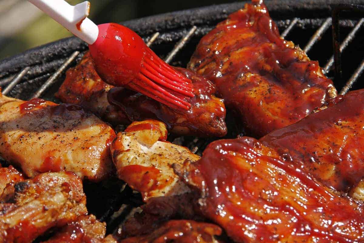 Applying sauce to grilled foods with a basting br.