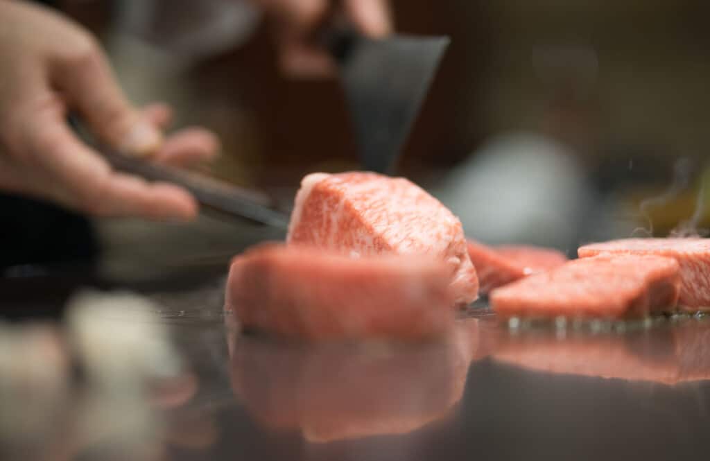 Close up of wagyu steak being cooked on a hibachi grill