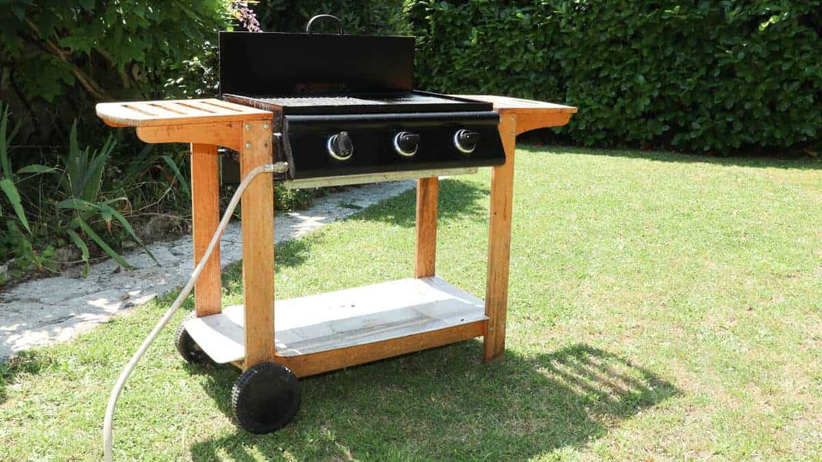 dedicated flat top gas grill on a grass lawn.