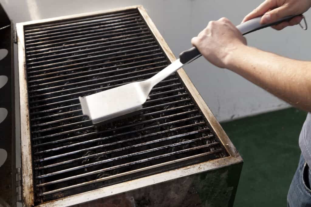Cleaning grill grates with a grill brush