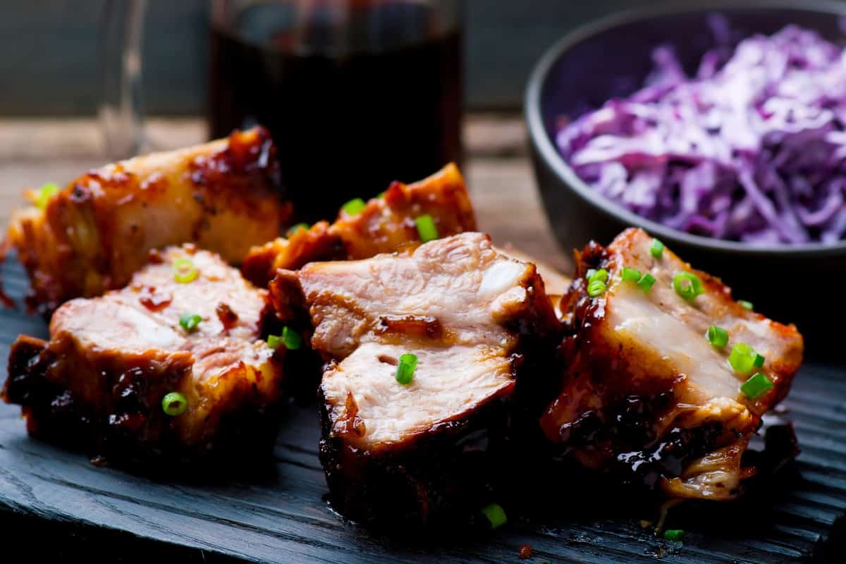 rustic country style ribs with bowl of red cabb.