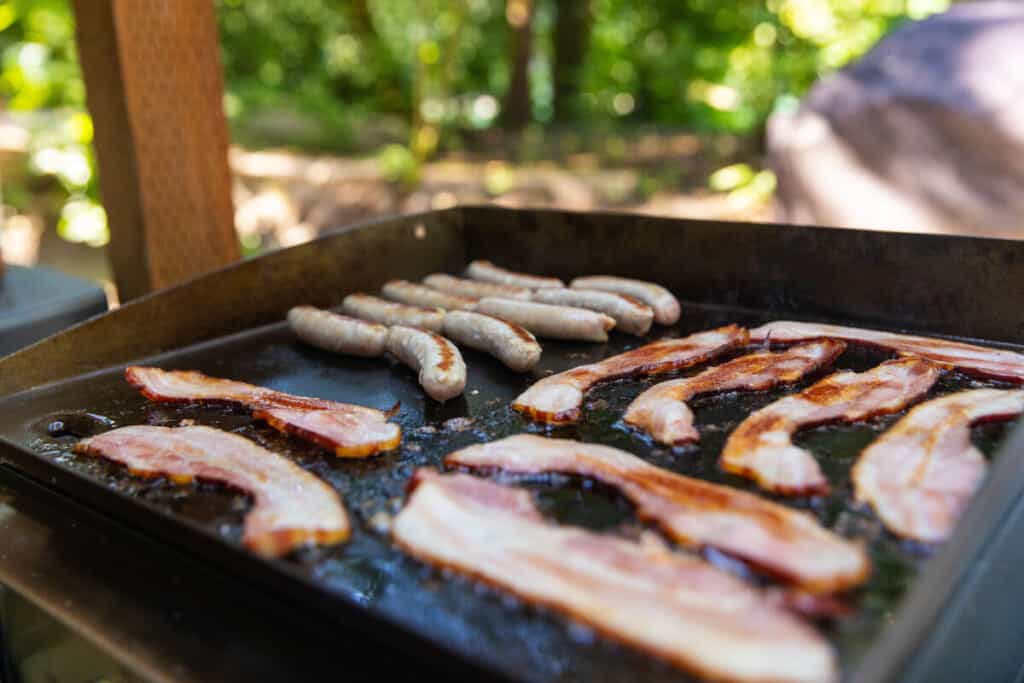 Lots of bacon cooking a flat top gr.
