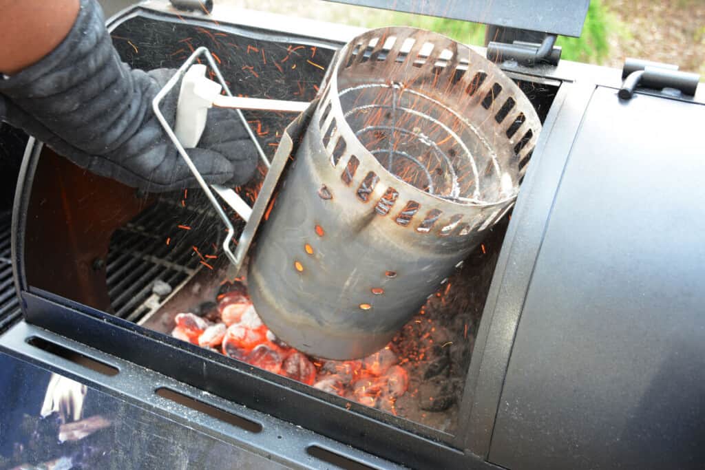 charcoal being emptied into the firebox of a smo.