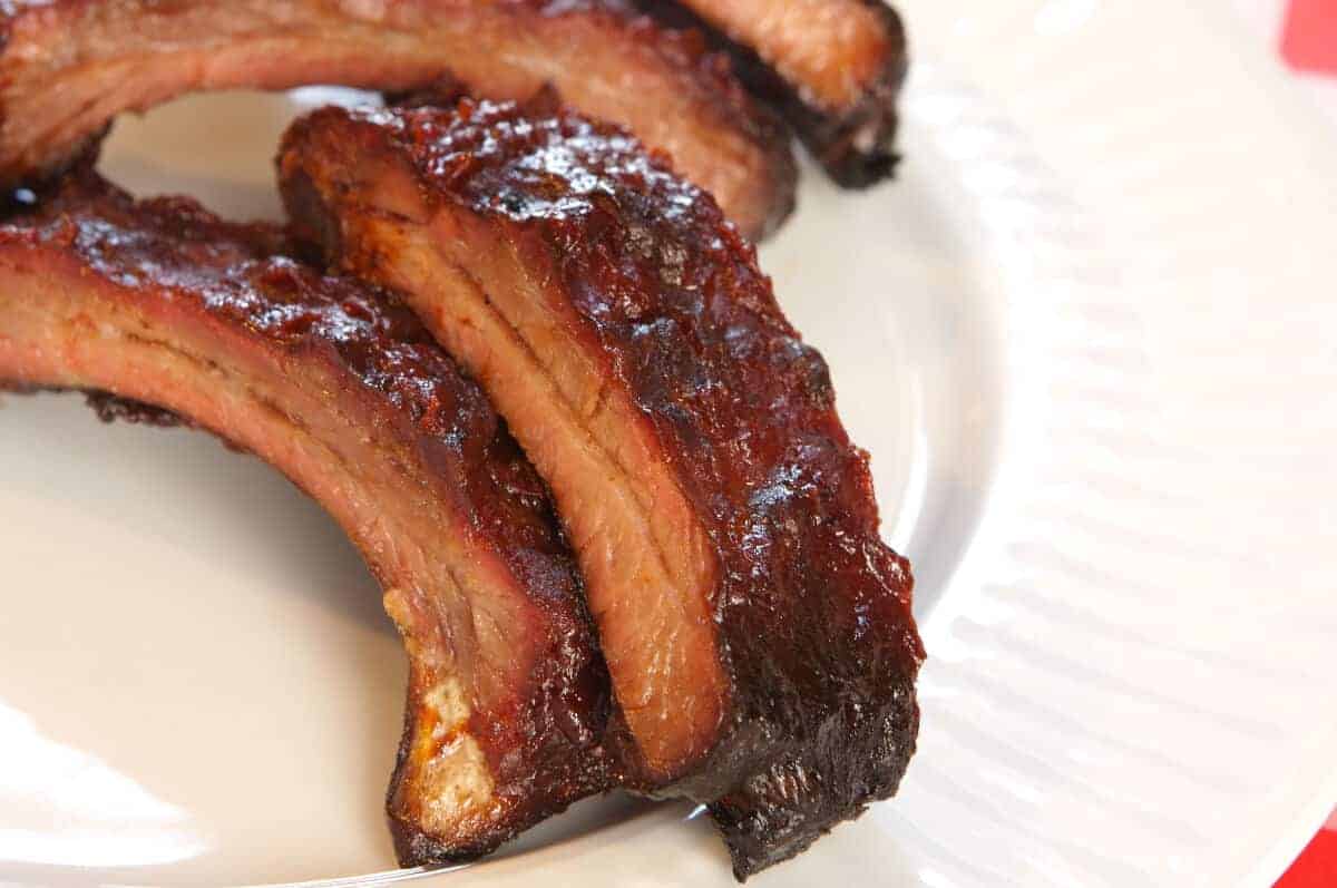 barbecue baby back ribs on a white pl.
