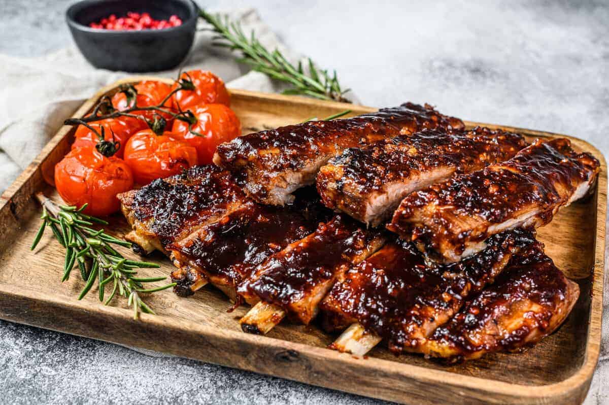 BBQ spare ribs, with a thick glaze and roasted cherry tomat.