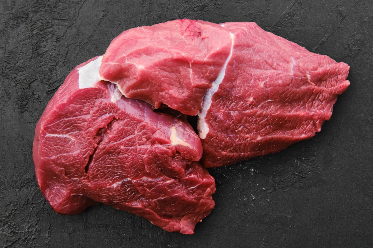 A lean chunk of chuck eye roast isolated on a black background