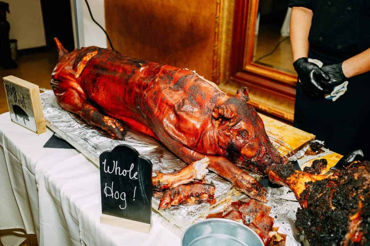 A smoked whole hog laid out on a ta.