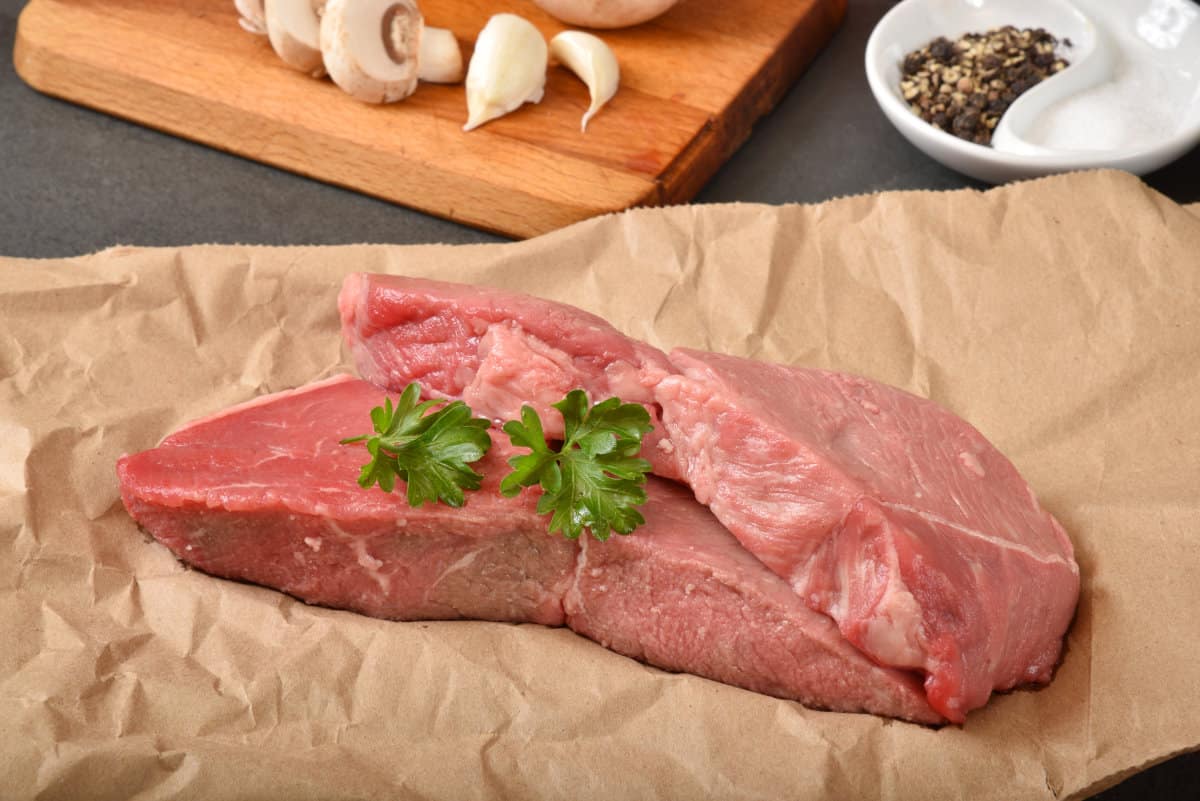 Uncooked beef petite sirloin steaks on butcher paper