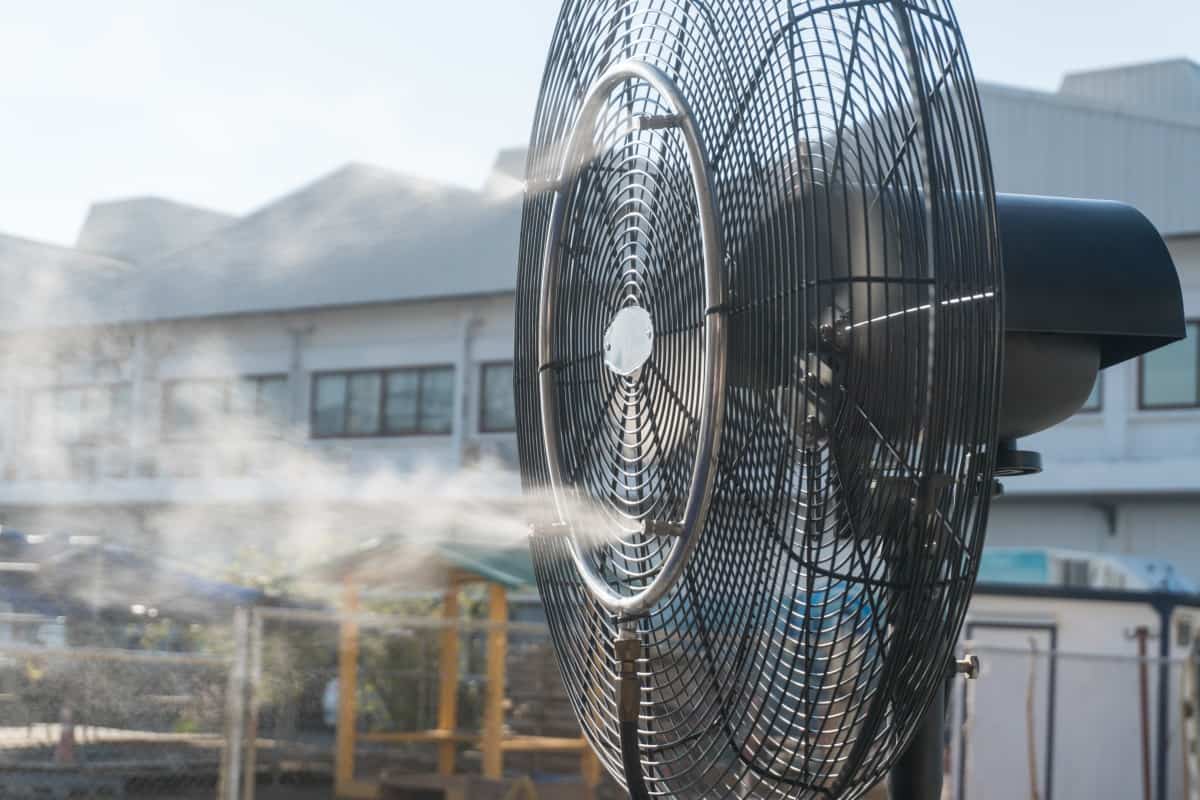 Close up of an misting fan blowing water