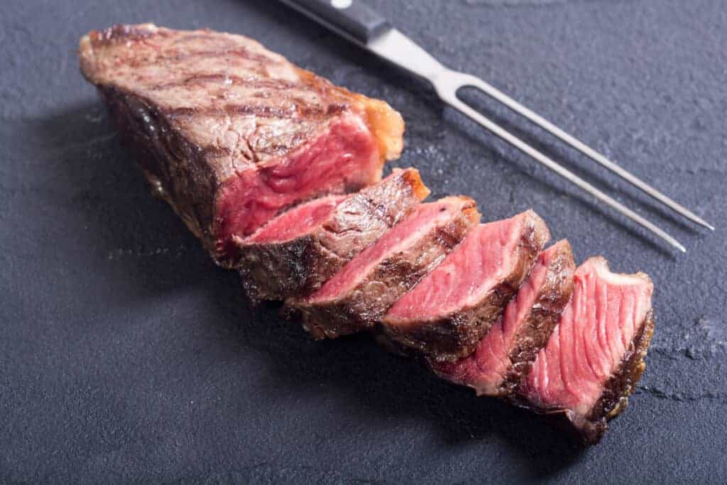 A grilled then sliced New York strip st.