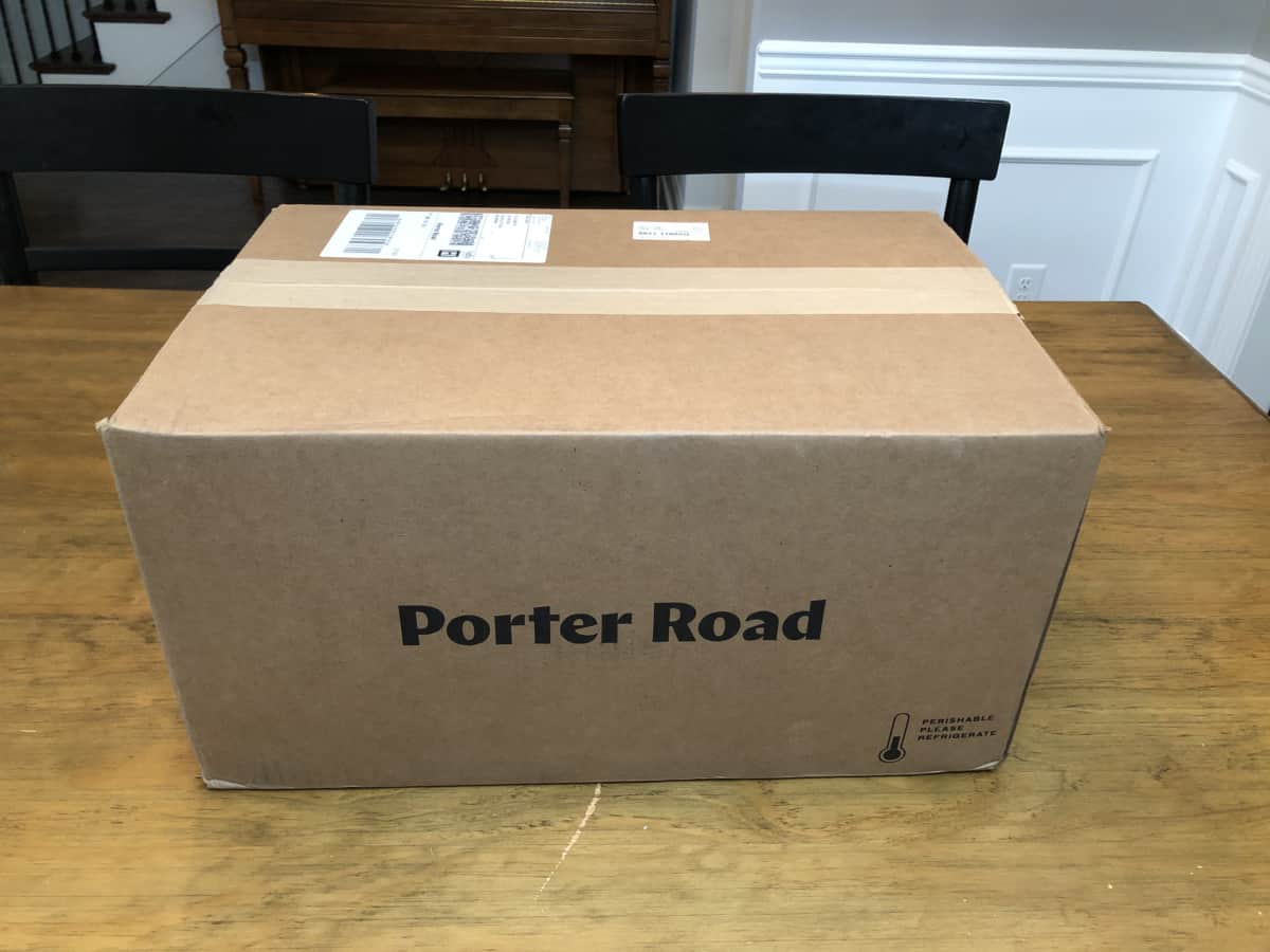A box delivered from Porter Road, on a wooden table.