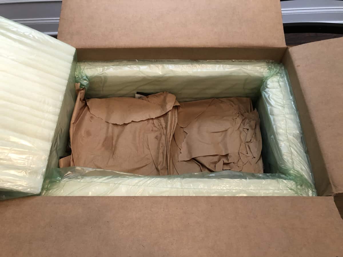 Porter road delivery box opened, with the ice packs removed, showing the brown paper wrapped meats inside