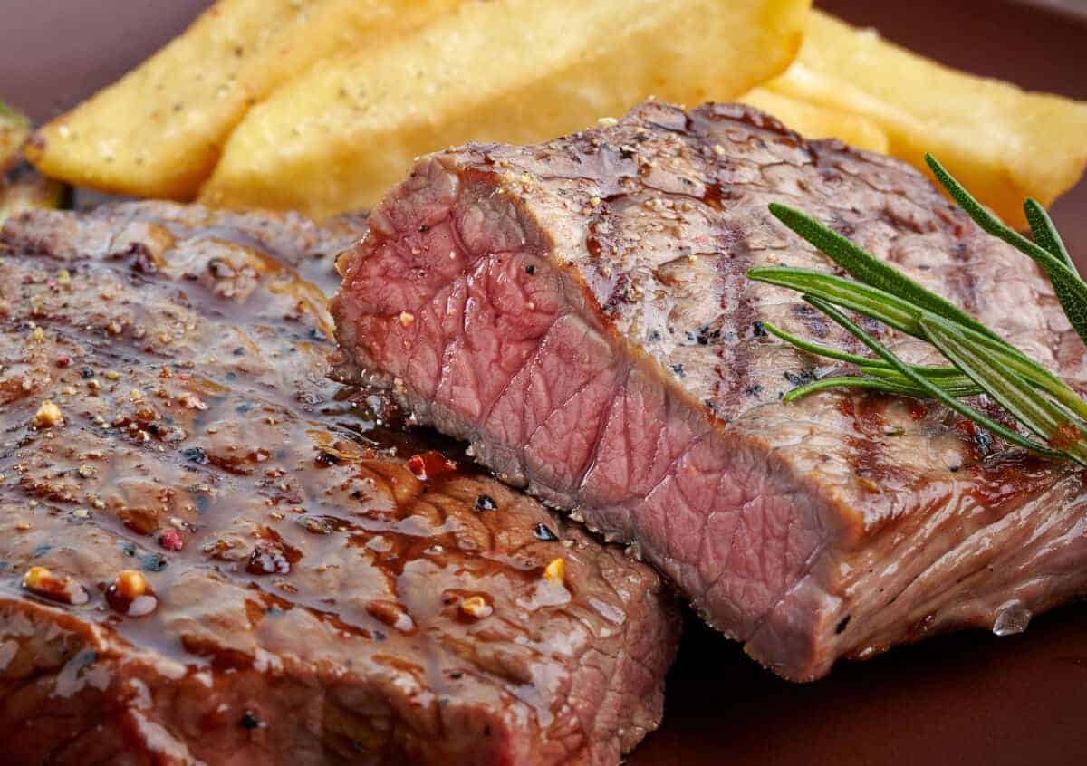 Grilled sirloin, cut in half showing a pink inter.