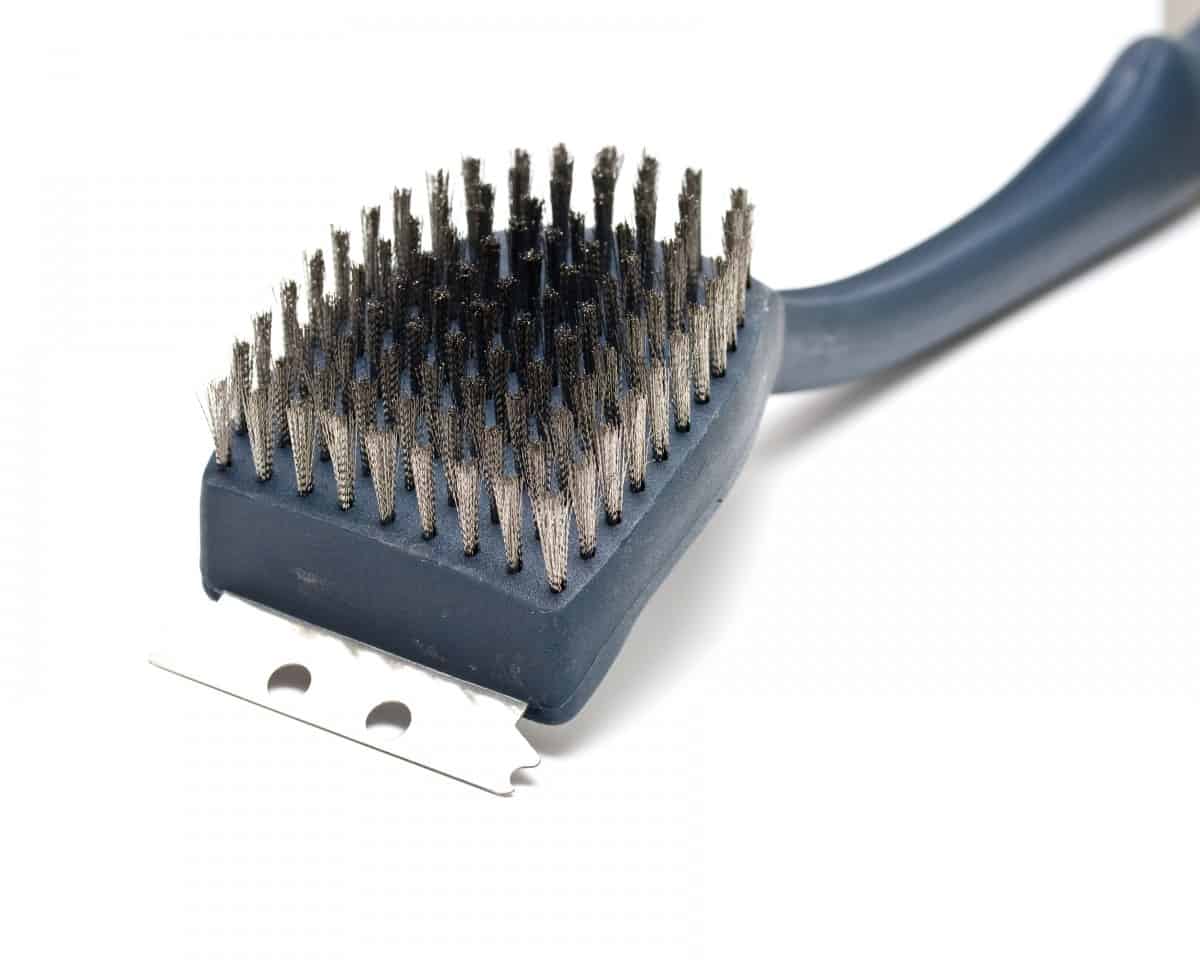 A plastic grill brush isolated on white