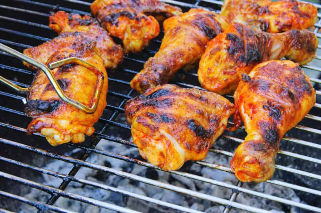 Chicken legs on a hot gr.