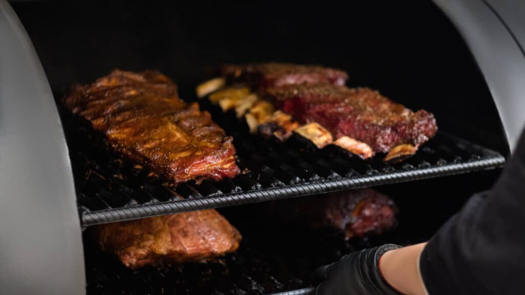 beef ribs in a BBQ smoker