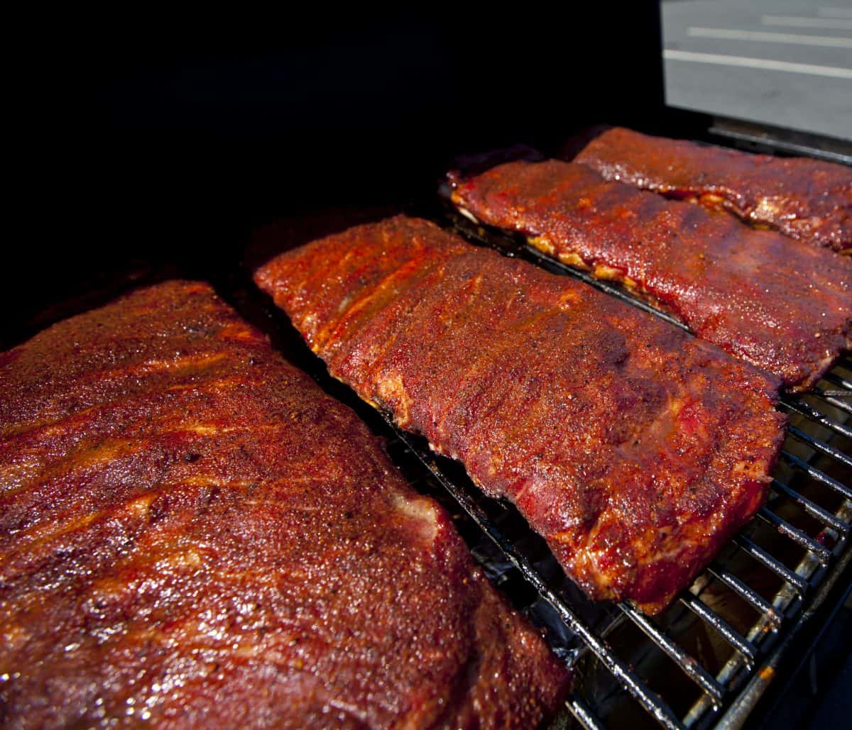 Racks of spare ribs in a smo.