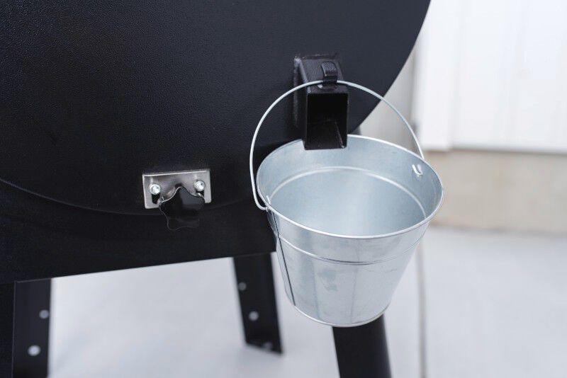Close up of the camp chef dlx grease bucket during use.