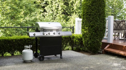 propane gas grill on patio.