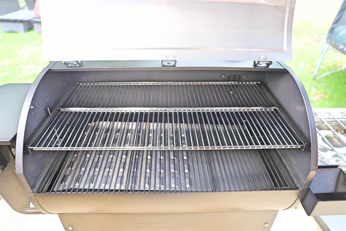 Camp Chef Woodwind Wi-Fi 36 with lid open, showing the upper and lower grates