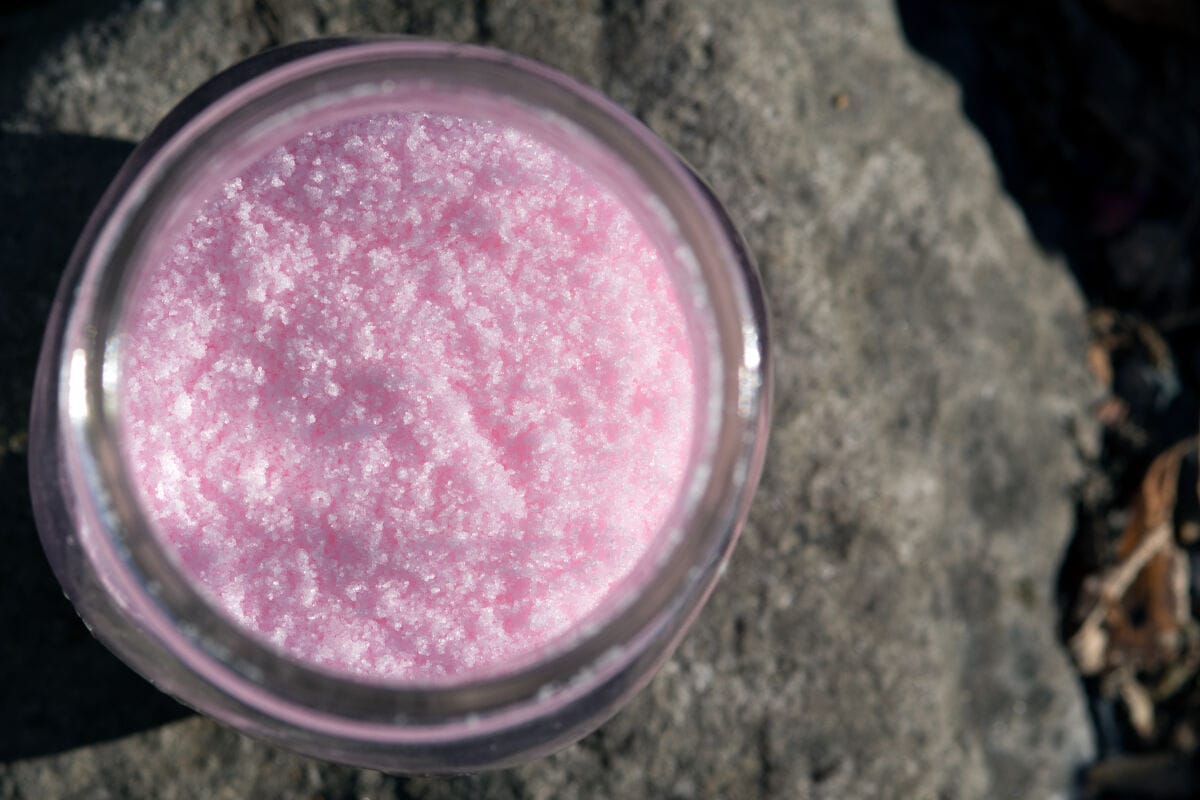 Top view of a glass jar full of pink curing s.