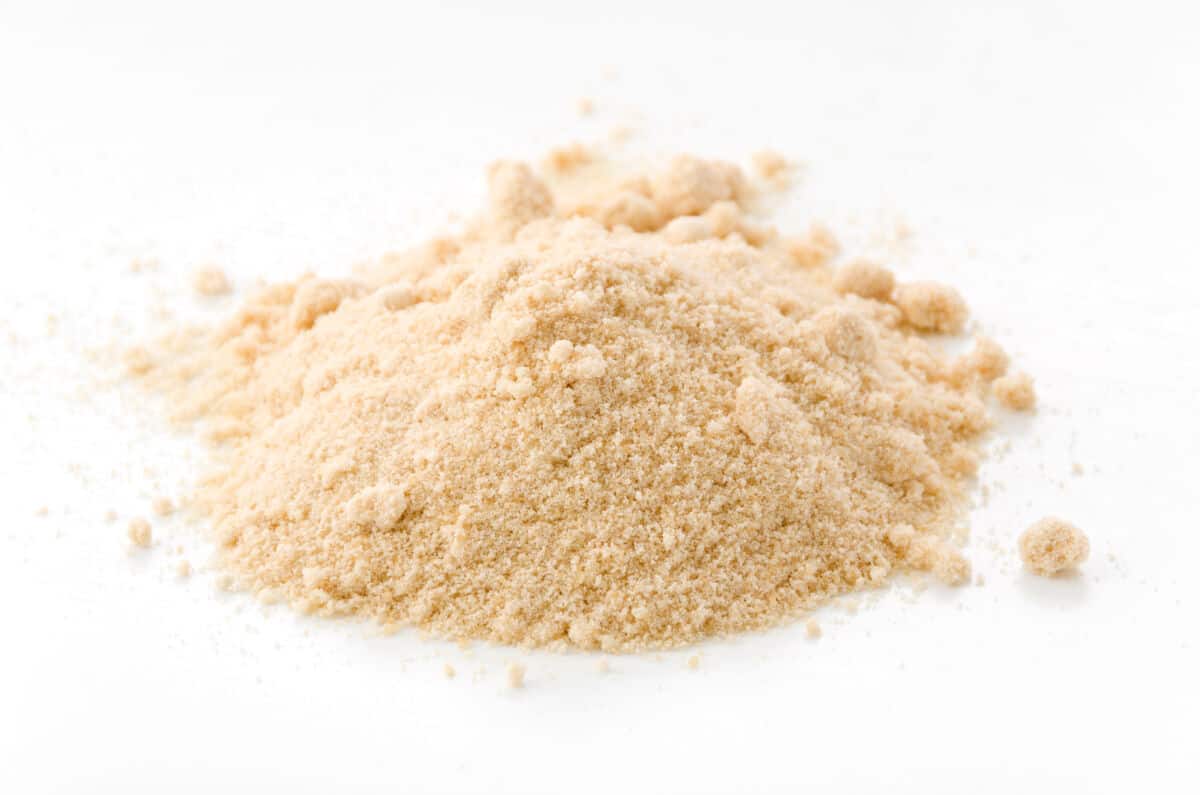 A pile of light brown sugar isolated on white
