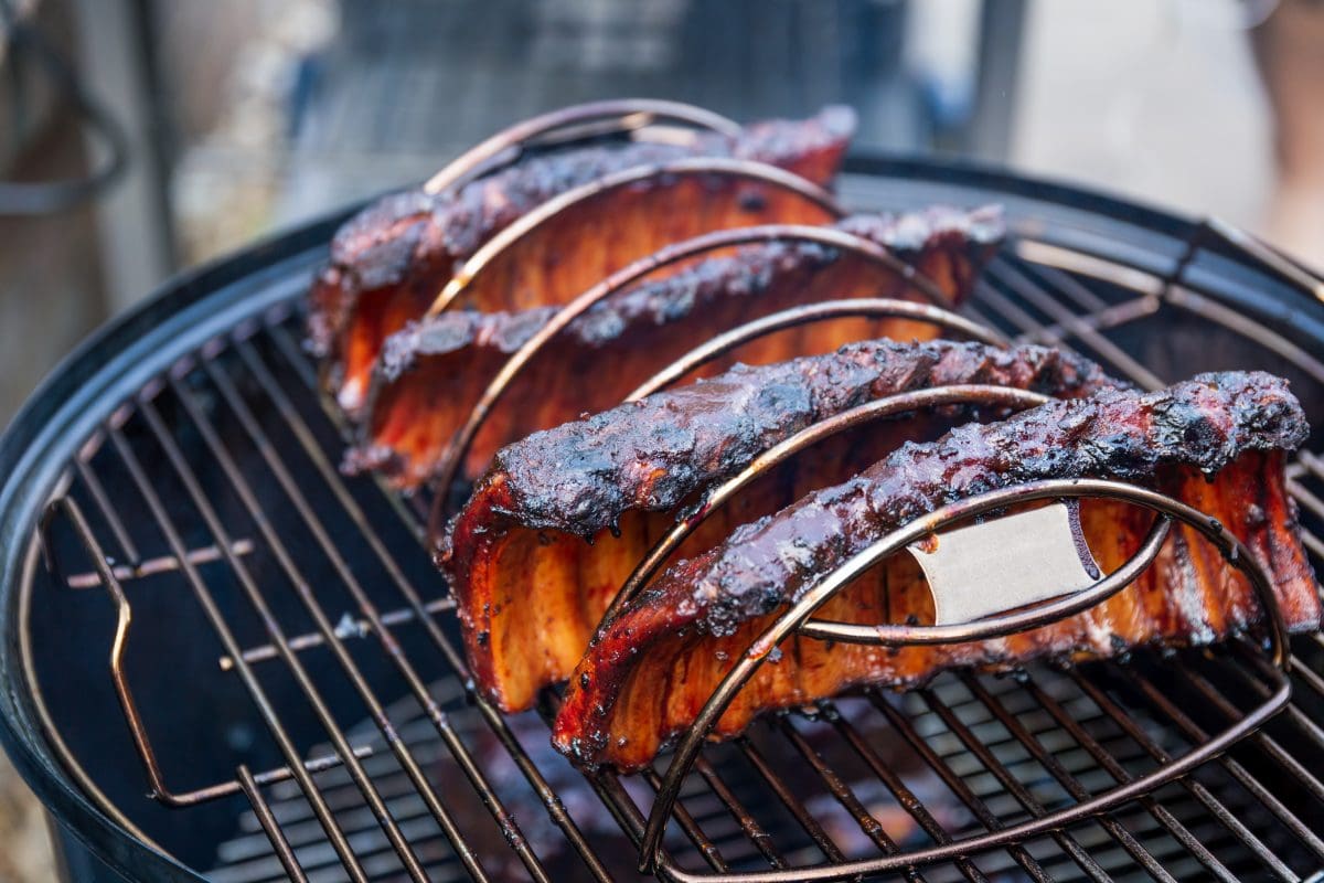 4 racks of ribs in an ugly drum smoker