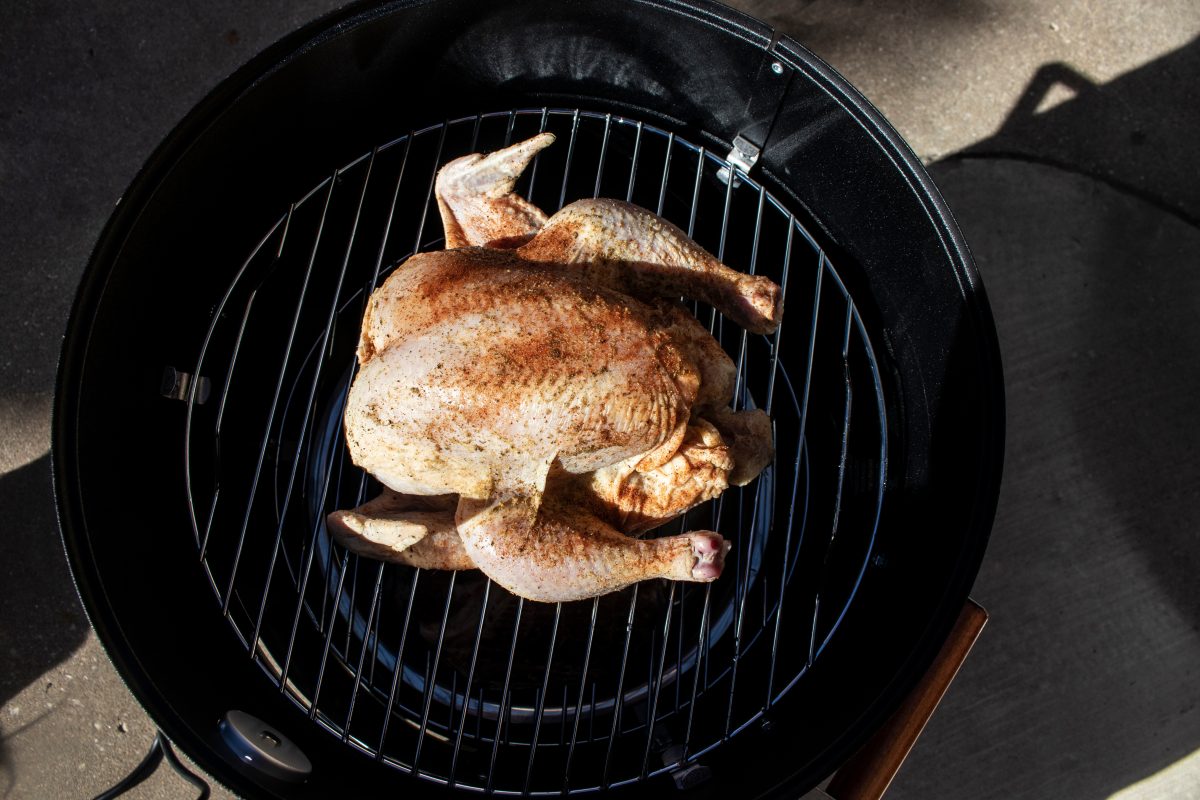 A smoked chicken on a drum smo.