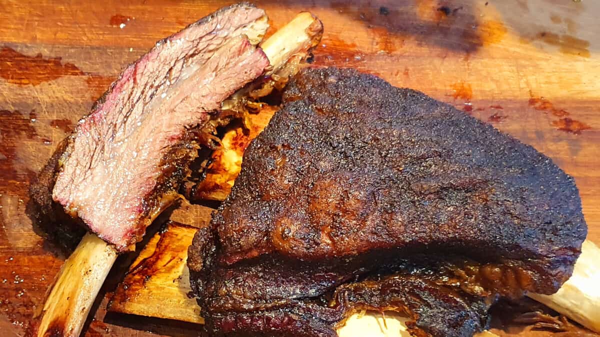 A rack of smoked beef ribs, one sliced off the end.