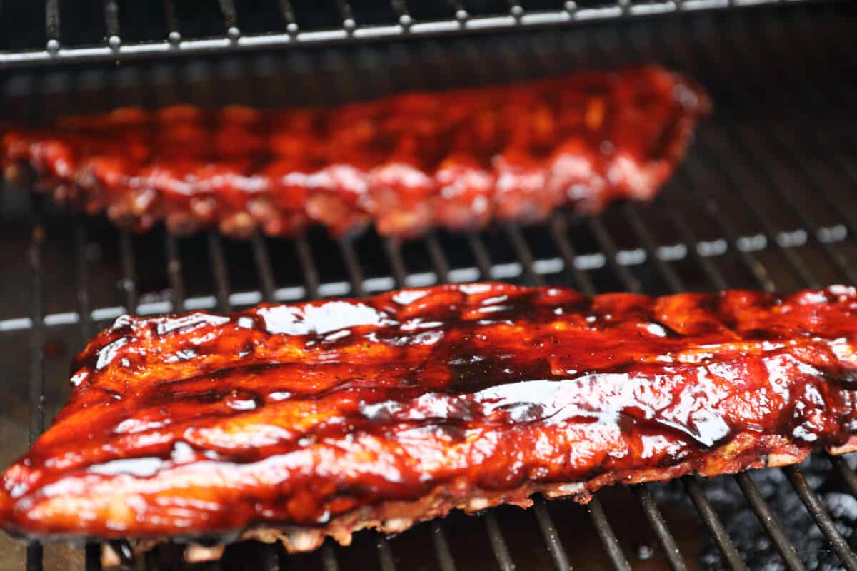 glazed ribs on grill grates.