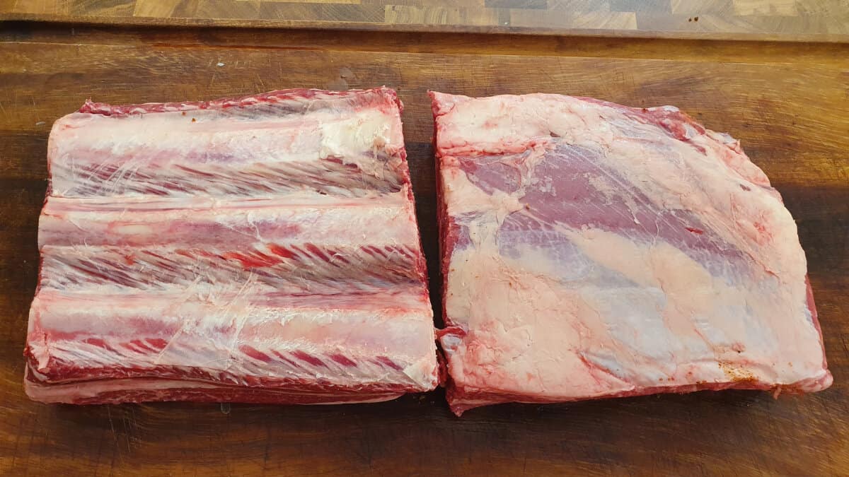 Two racks of raw beef ribs.