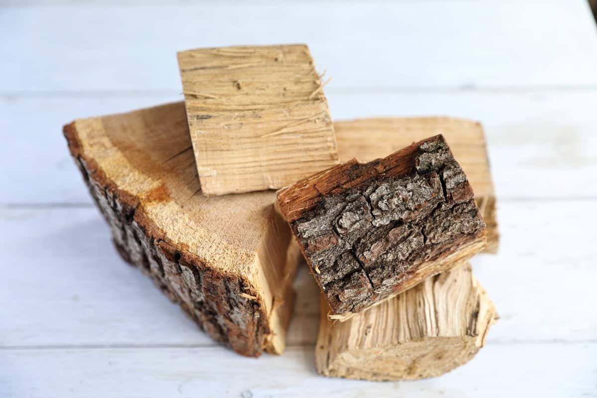 Chunks of oak smoking wood on a white wooden backgro.