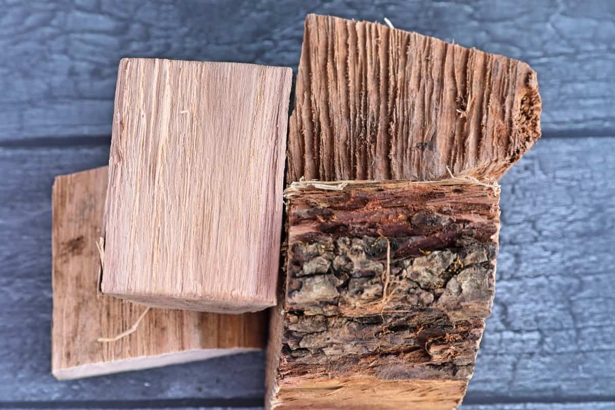 Pecan wood chunks on a gray wooden background.