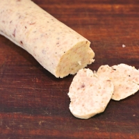 sliced bone marrow butter on a wooden cutting board.