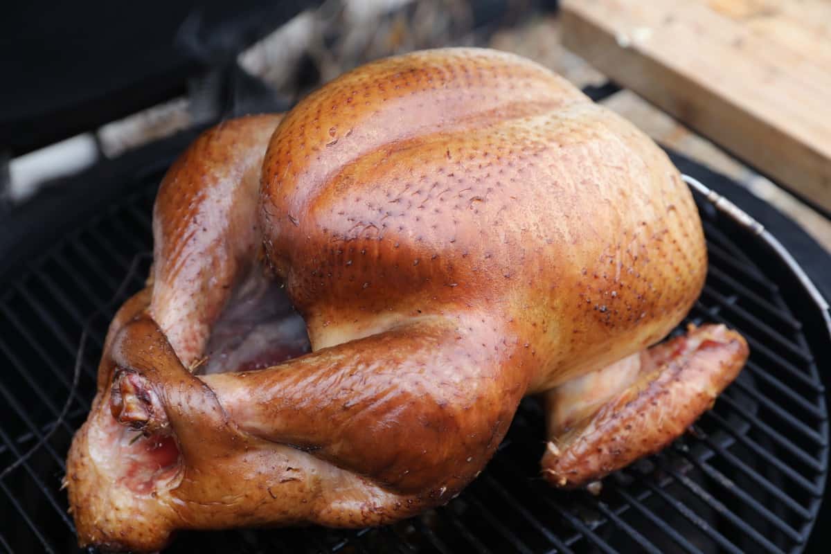 Close up of a whole turkey on kamado smoker, being BBQ'd for thanksgiv.