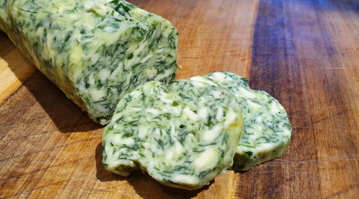 Close up of sliced wild garlic compound butter.