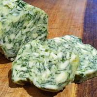 Close up of sliced wild garlic compound butter.