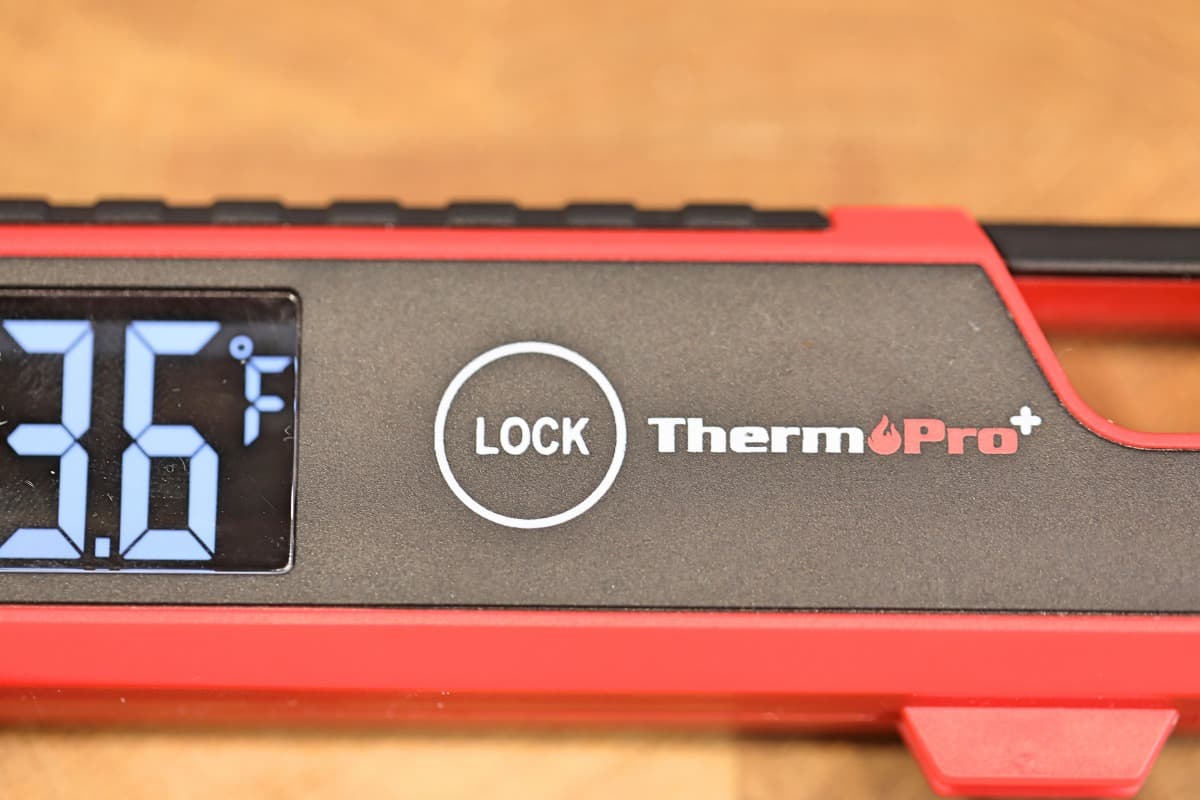 A close up of the TP620 thermometer lock button.