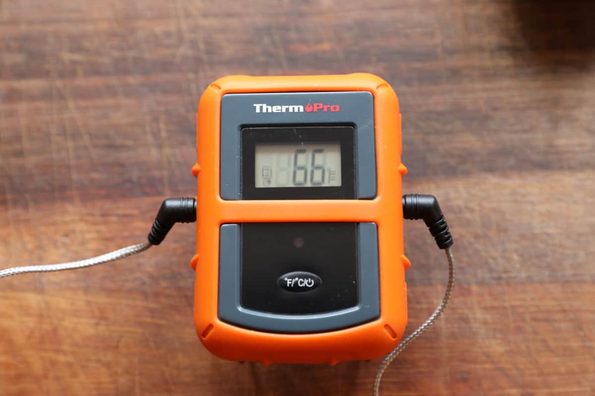 Thermopro tp20 transmitter on a wooden surface.