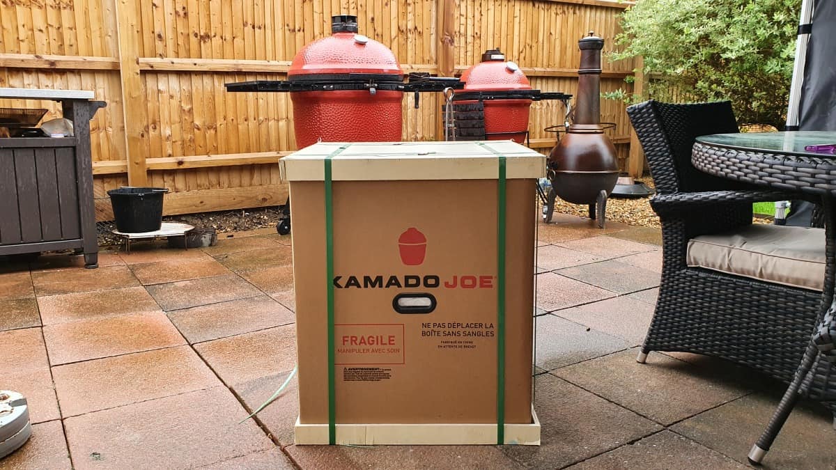 Kamado Joe jr. In crate, in front of the classic and Big Joe size gri.