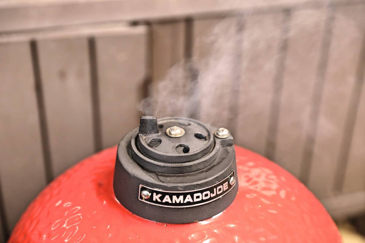 Smoke from the top vent of a Kamado Joe Jr grill