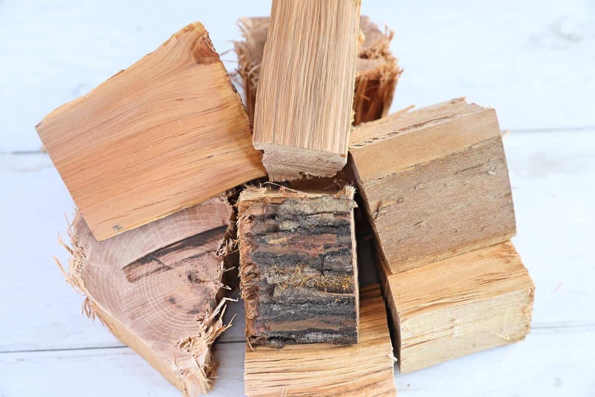 A pile of hickory wood chunks on a white table.