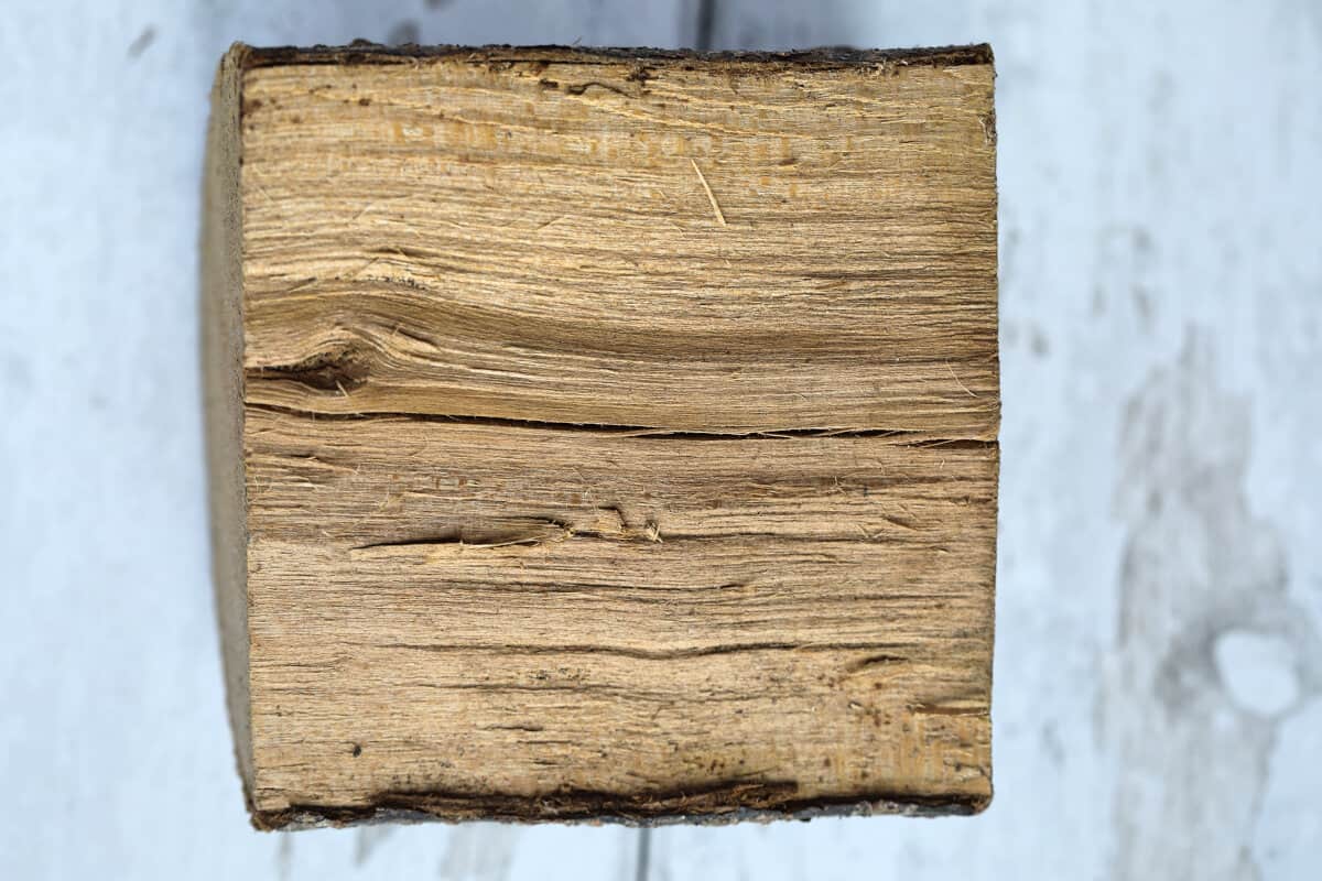 A close up of the grain of a chunk of plum smoking wood.